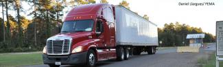 Red tractor trailer truck. Photo by Daniel Llargues, FEMA