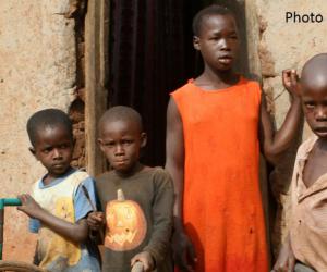 Four boys and a girl outside an building in Africa