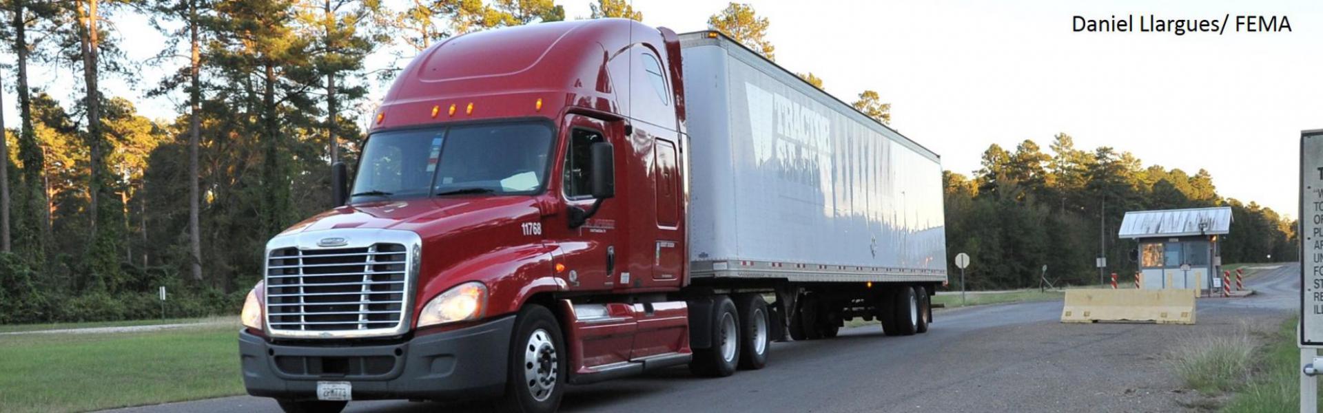 Red tractor trailer truck. Photo by Daniel Llargues, FEMA