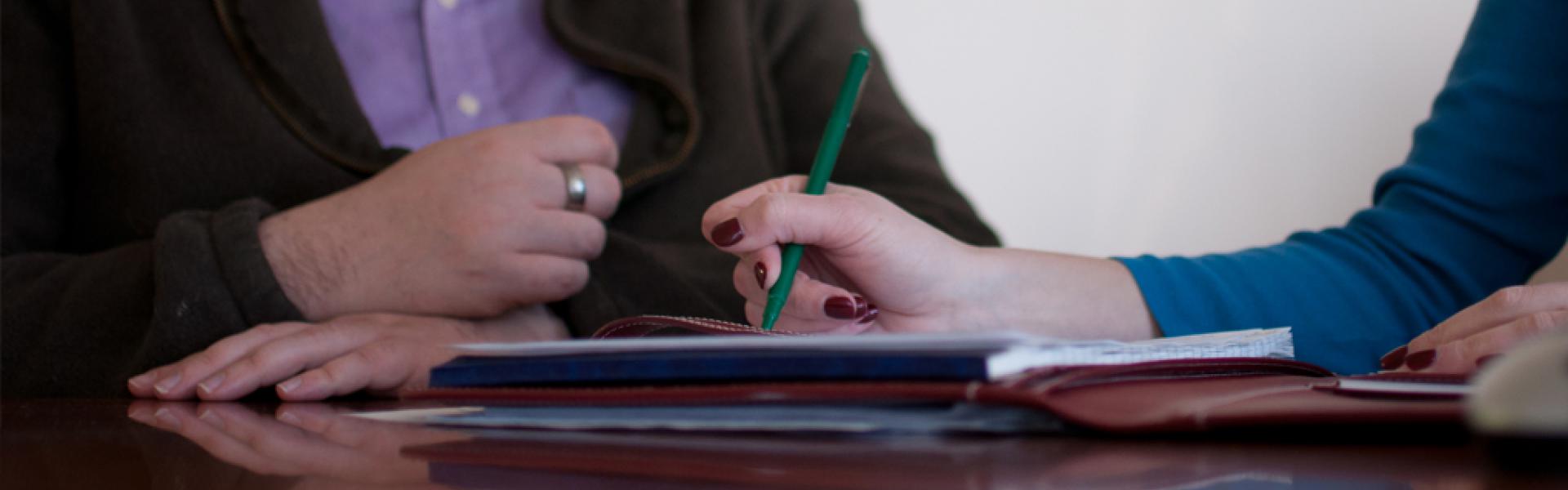 Two individuals working on a report.