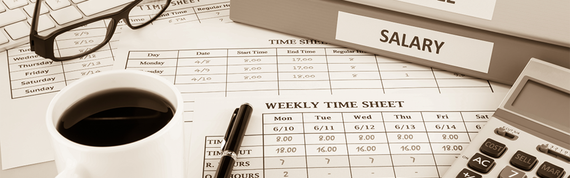 A desk with coffee, eye glasses, timesheets, and a few folders - one marked as salary on it